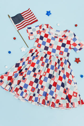 HOME OF THE FREE CHECKERS DREAM RUFFLE DRESS